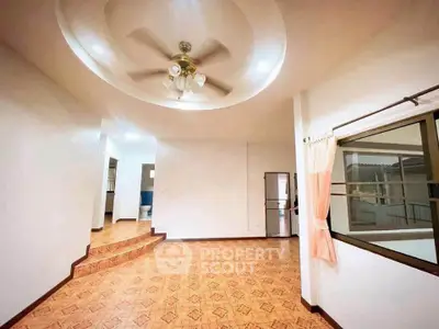 Spacious living room with unique ceiling design and tiled flooring