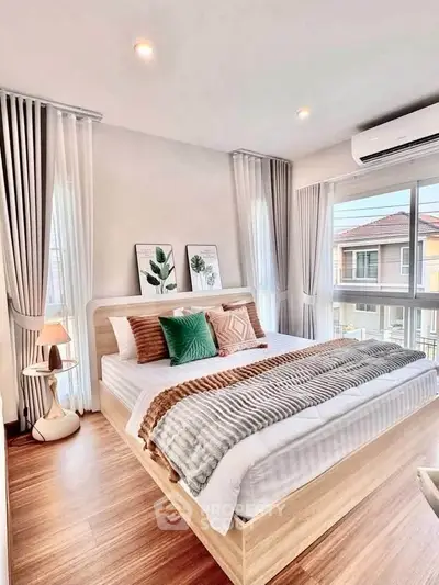 Bright and airy bedroom with modern decor and large windows in a stylish home.