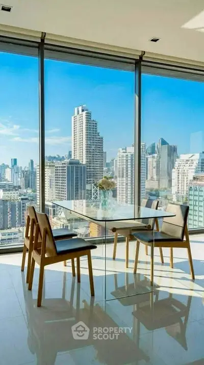 Stunning dining area with panoramic city skyline views through floor-to-ceiling windows.