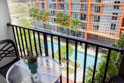Charming balcony with pool view in modern apartment complex