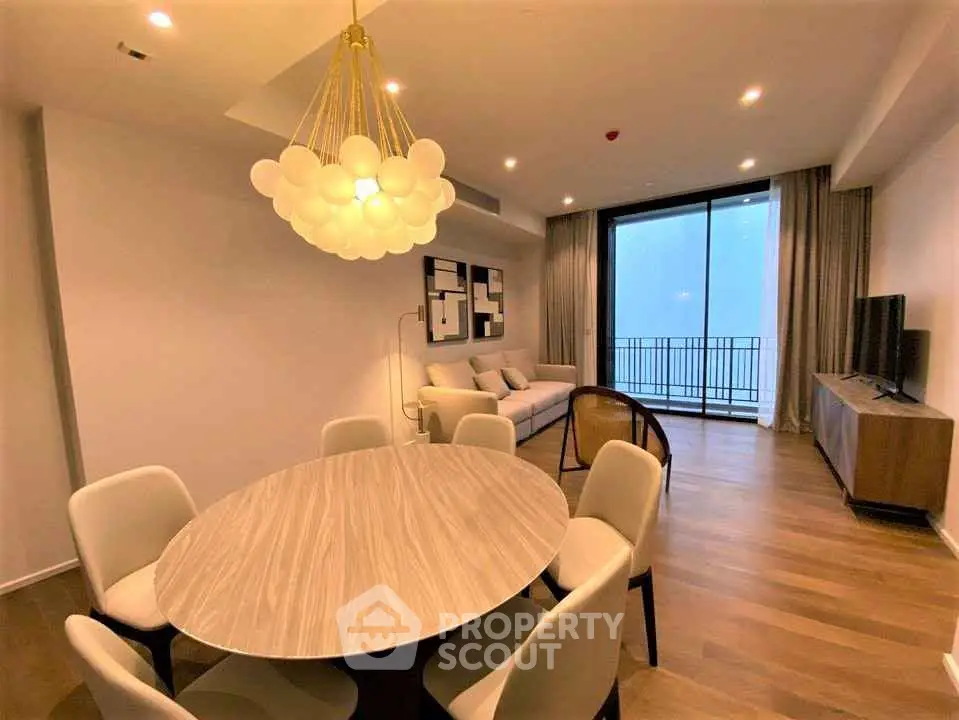 Elegant living room with modern chandelier and balcony view