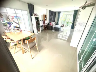 Spacious living room with modern decor and large windows for natural light