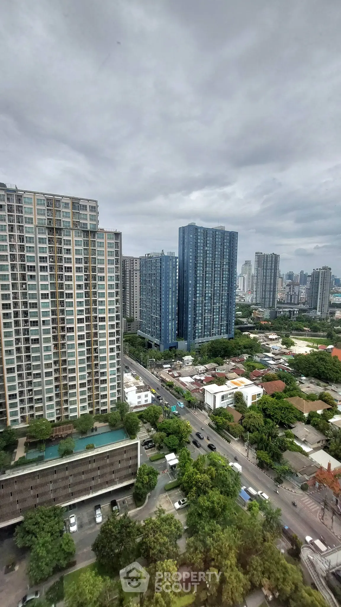 Stunning cityscape view showcasing modern high-rise buildings and lush greenery, perfect for urban living.