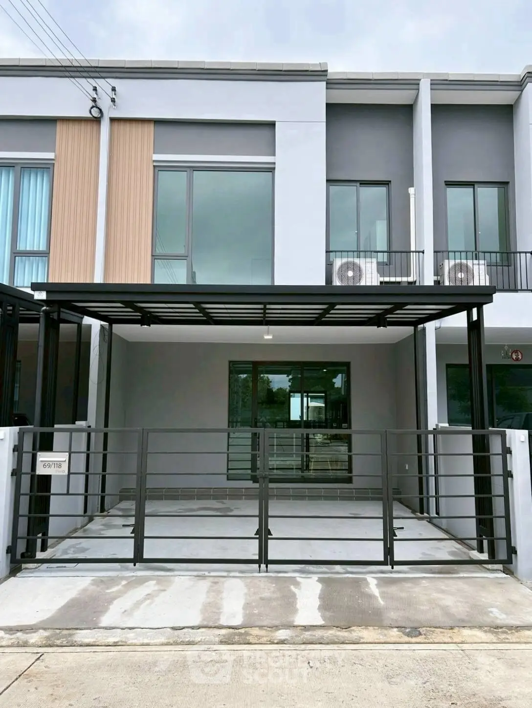 Modern townhouse exterior with sleek design and spacious driveway