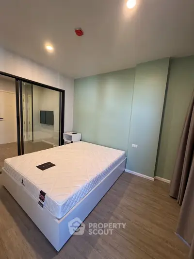 Modern bedroom with minimalist design and large mirrored closet