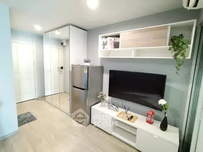 Modern living room with sleek design, mirrored closet, and wall-mounted TV for stylish urban living.