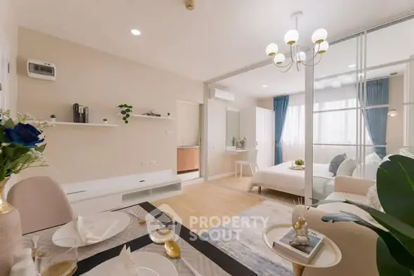 Modern open-plan living room and bedroom with elegant decor and natural light