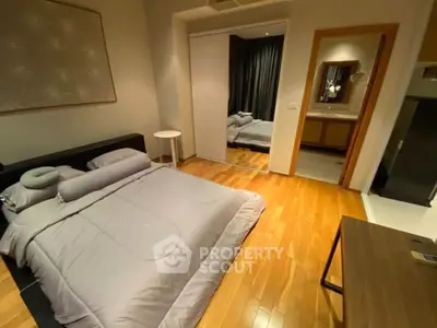 Modern bedroom with wooden flooring and mirrored closet doors
