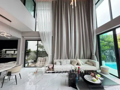 Luxurious modern living room with high ceilings, elegant decor, and pool view, perfect for sophisticated living.