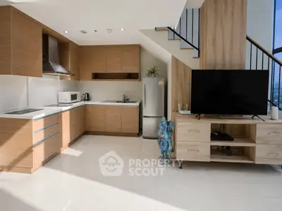 Modern kitchen with open layout and sleek appliances in a stylish apartment