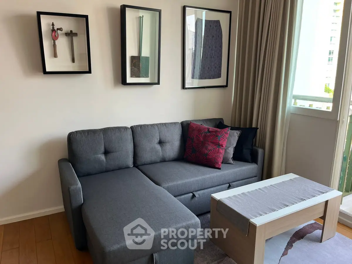 Modern living room with stylish gray sofa and contemporary art decor