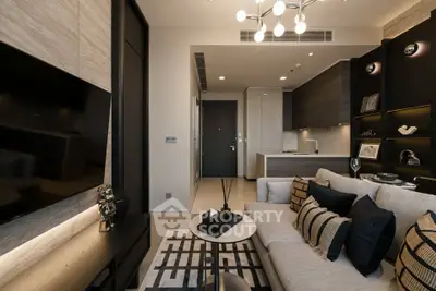 Modern living room with stylish decor and open kitchen layout in luxury apartment.