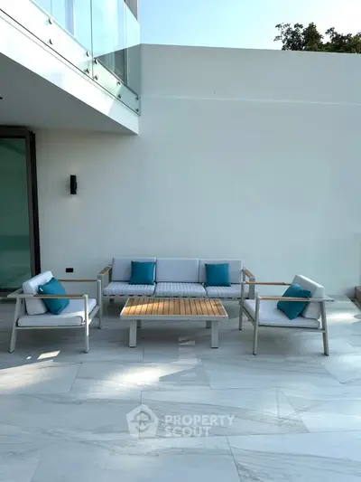 Modern outdoor patio with stylish furniture and sleek design, perfect for relaxation and entertaining.