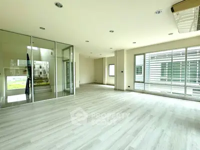 Spacious modern living room with large windows and sleek flooring