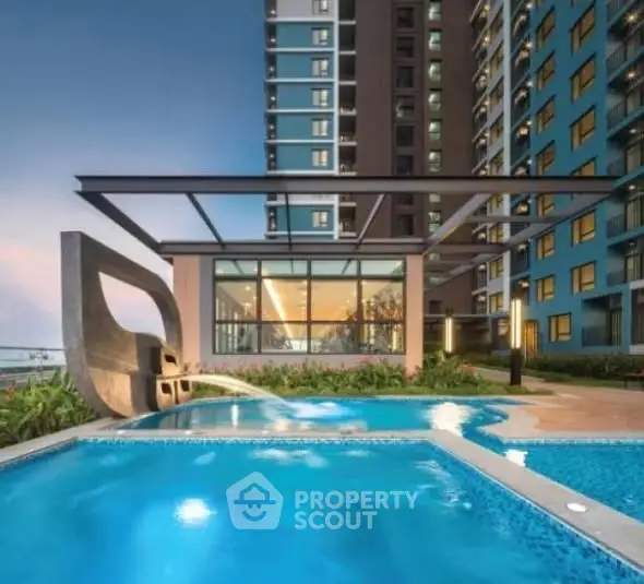 Luxurious modern apartment complex with stunning pool and architectural design.