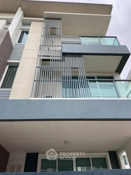 Modern apartment building with sleek balcony design and contemporary architecture.