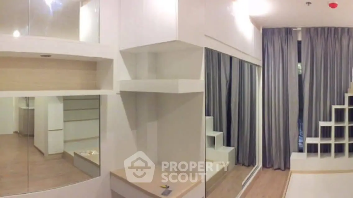 Modern minimalist living room with large mirrors and sleek shelving units.