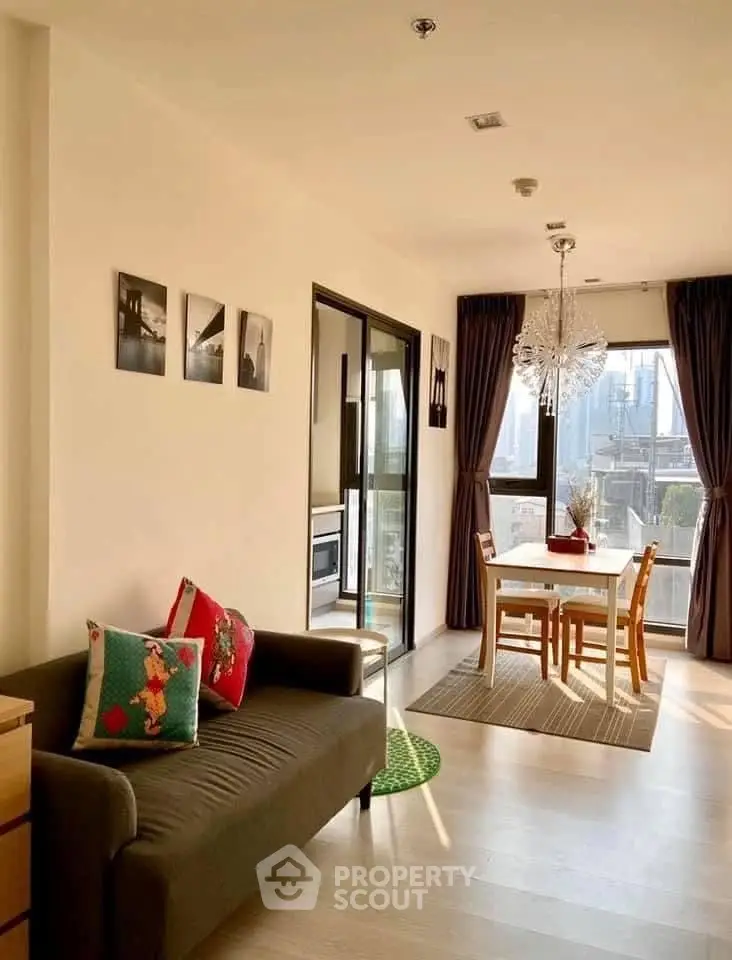 Bright living room with dining area and city view, featuring modern decor and natural light.