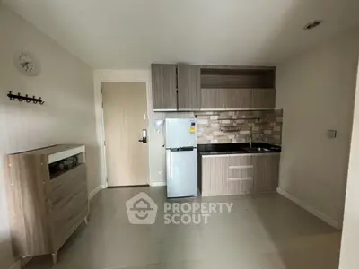 Modern compact kitchen with sleek cabinetry and tiled backsplash