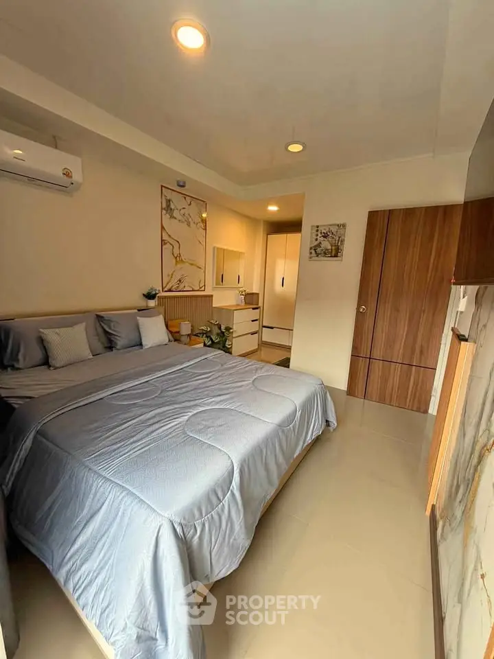Spacious bedroom with modern decor and cozy ambiance