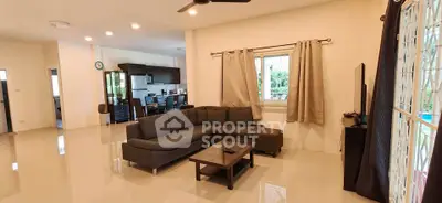 Spacious modern living room with sleek furniture and open layout, perfect for family gatherings.