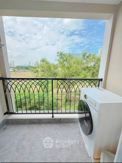 Charming balcony with scenic view and modern washing machine, perfect for urban living.