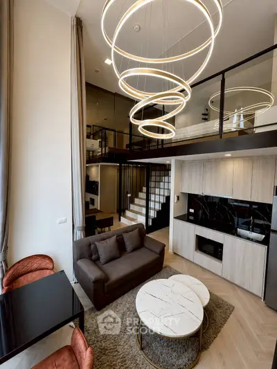 Luxurious modern living room with high ceilings and stylish lighting in a loft apartment.