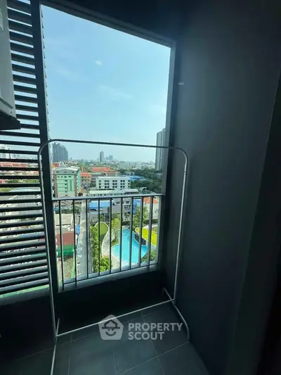 High-rise balcony with stunning cityscape and pool view, perfect for urban living.