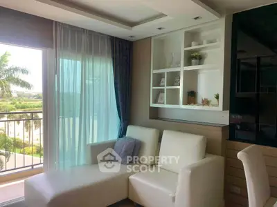 Stylish living room with white sofa and balcony view in modern apartment