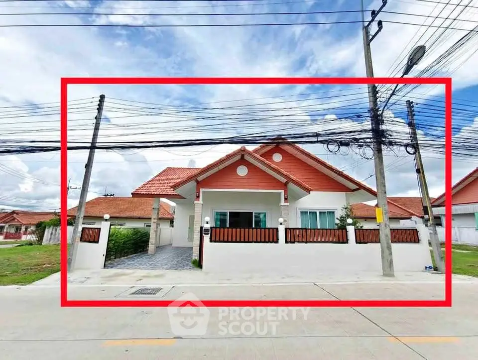 Charming single-story house with red roof and white facade in a serene neighborhood.