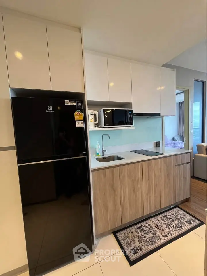 Modern kitchen with sleek cabinetry and appliances in a stylish apartment.