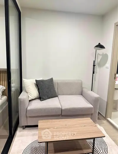 Modern living room with cozy sofa and stylish floor lamp