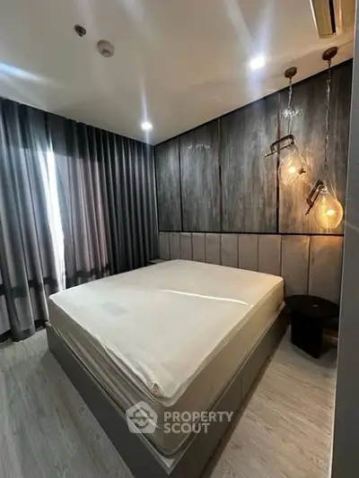 Modern bedroom with stylish lighting and floor-to-ceiling curtains