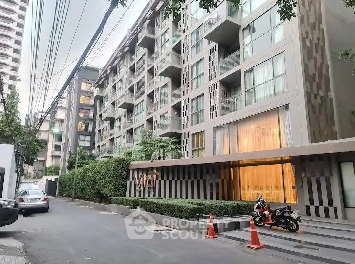 Modern urban apartment building with stylish facade and lush greenery