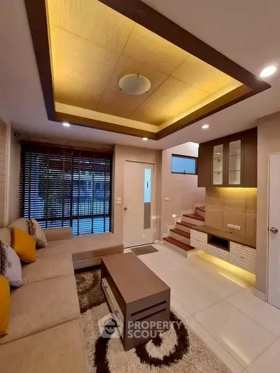 Modern living room with stylish ceiling and cozy seating area