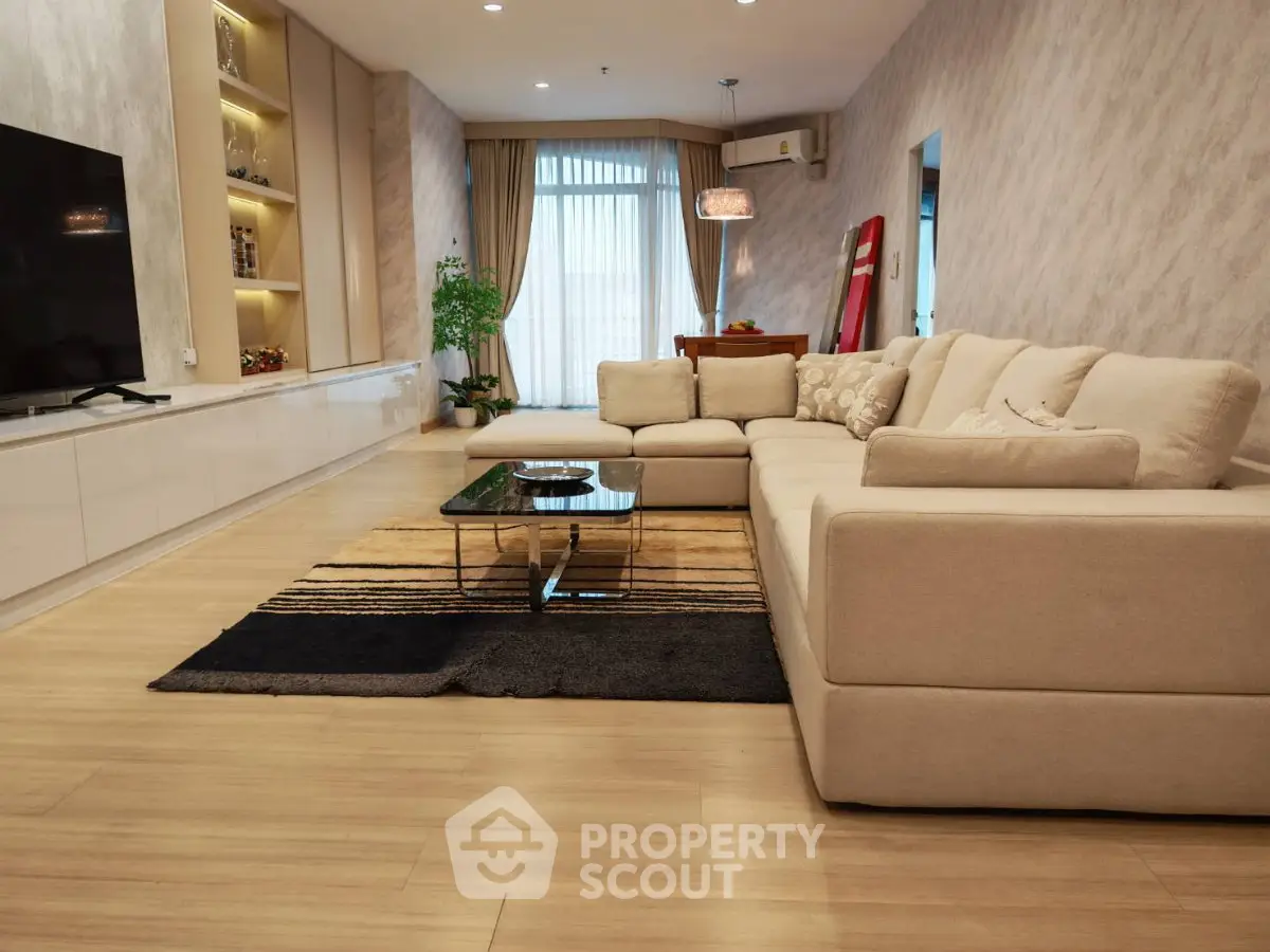 Spacious modern living room with elegant decor and large sectional sofa, perfect for relaxation and entertainment.