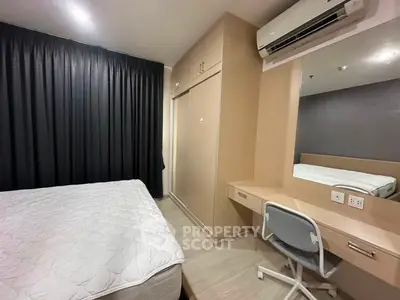 Modern bedroom with built-in wardrobe and study desk, featuring sleek air conditioning unit and cozy ambiance.
