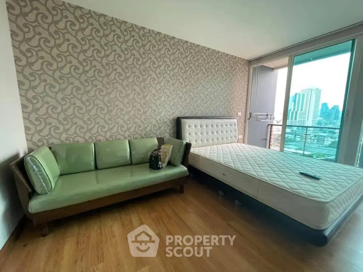 Modern bedroom with city view, featuring stylish furniture and elegant decor.