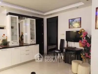 Modern living room with sleek white cabinetry and stylish decor