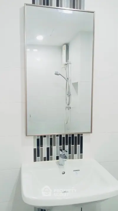 Modern bathroom with sleek sink and mirror design