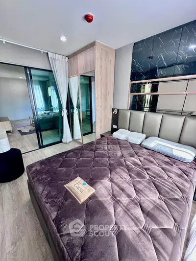 Luxurious bedroom with plush bedding and modern decor in a stylish apartment.