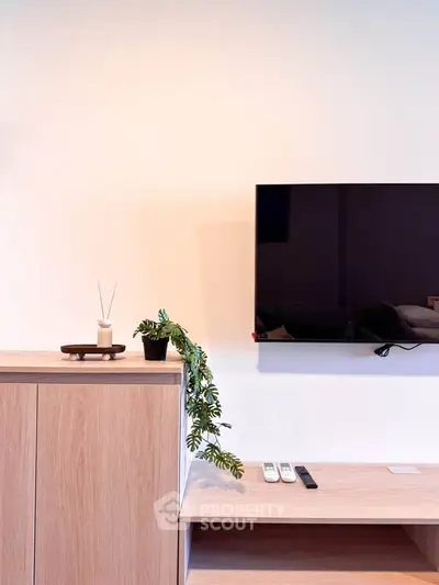 Modern living room with sleek TV setup and stylish wooden cabinet