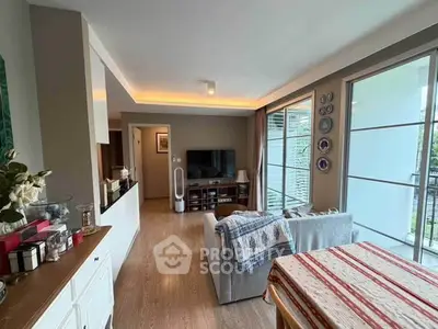 Spacious living room with modern decor and large windows offering natural light.