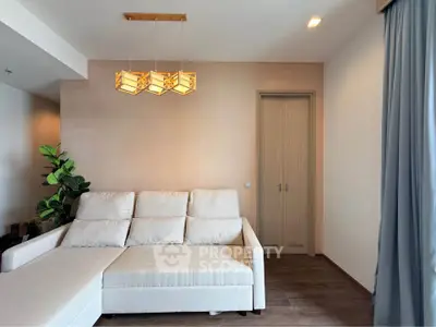 Modern living room with stylish lighting and cozy beige sofa