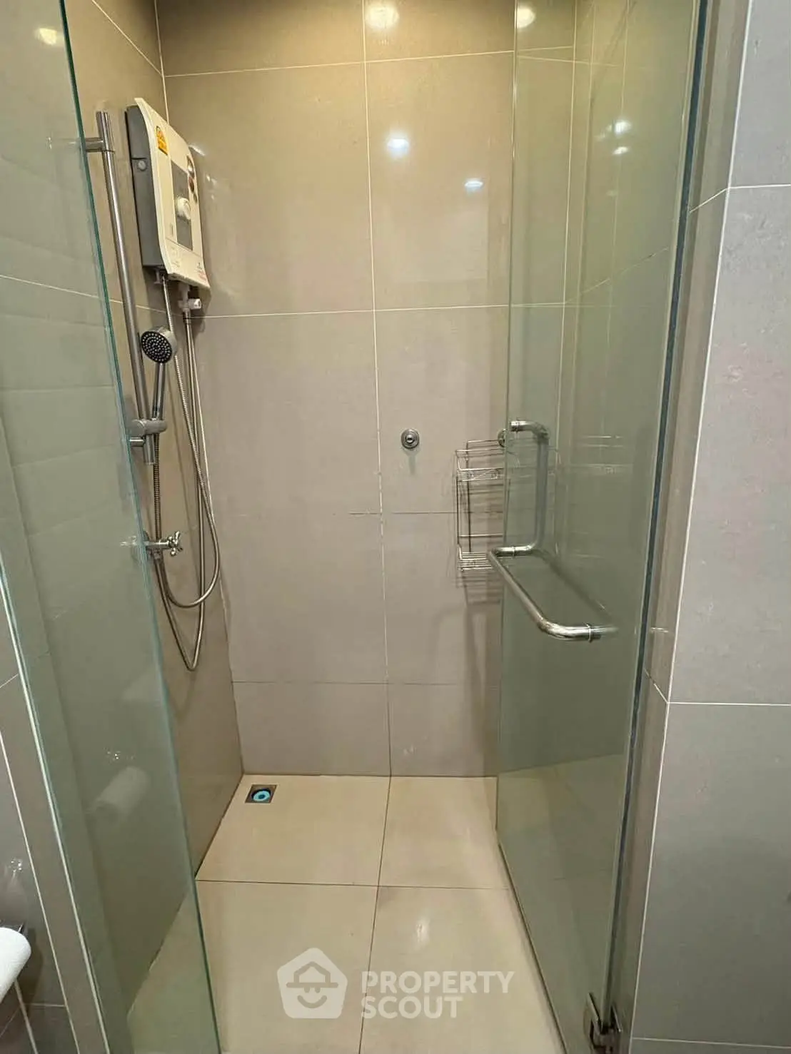 Modern bathroom with glass shower enclosure and sleek fixtures