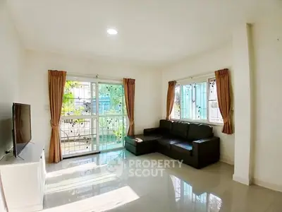 Bright living room with large windows and modern furniture