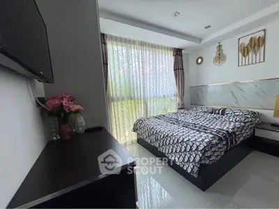Modern bedroom with elegant decor and large window for natural light
