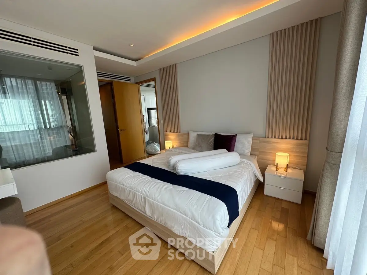 Luxurious bedroom with modern design and ambient lighting, featuring a cozy bed and elegant decor.