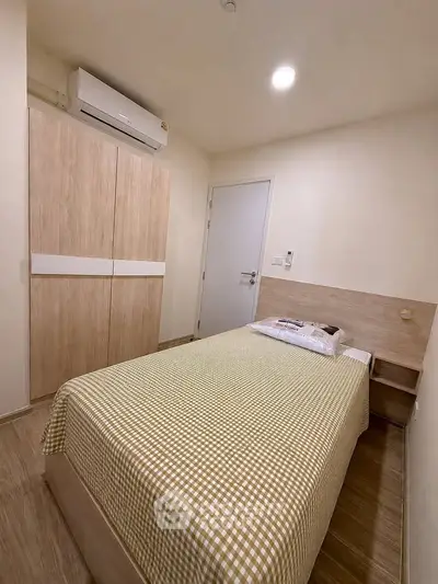Cozy bedroom with modern air conditioning and stylish wardrobe in a compact layout.