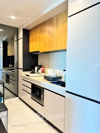 Modern kitchen with sleek cabinetry and built-in appliances